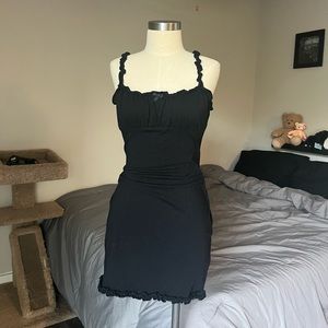 fitted black dress, ruffle detailing on straps/around hemming with a little bow